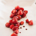 frozen strawberries on parchment paper with balsamic vinegar