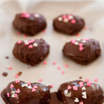 heart-shaped cakes with chocolate ganache and heart-shaped sprinkles