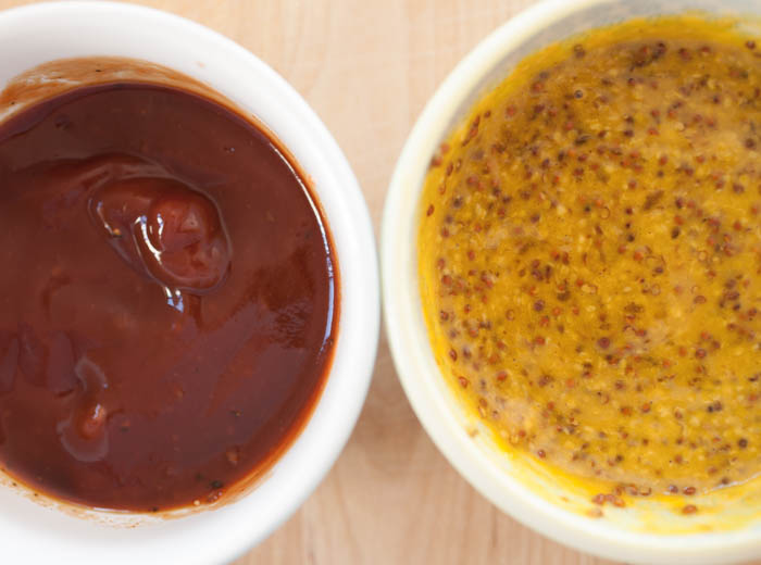 two homemde dipping sauces, grainy mustard and spicy ketchup