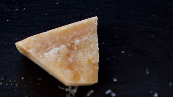 Parmesan cheese on a black background