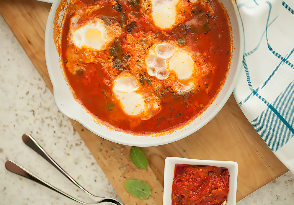 Silky, just-set eggs nestled in a savory tomato sauce with some wilted greens and Parmesan melted and just beginning to brown on top—these savory baked eggs are heaven! They’re also done in under 30 minutes for a quick, healthy weeknight meal! 