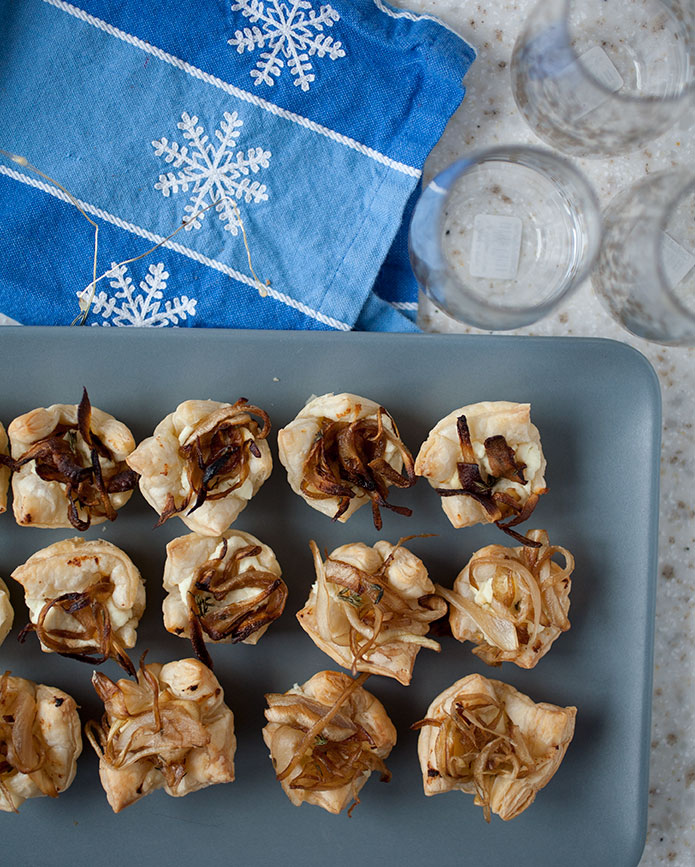 These caramelized onion and goat cheese tarts only require a handful of ingredients, aren’t very labor intensive, and the sweet-savory flavors meld perfectly in the flaky pastry crust! These holiday appetizers will fly off the plate!