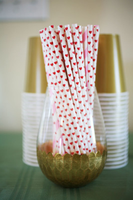 Gold party glass with decorative straws