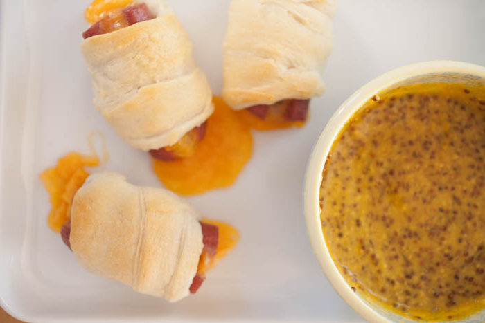 honey mustard sauce with cheese-filled and crescent-wrapped hot dogs. 