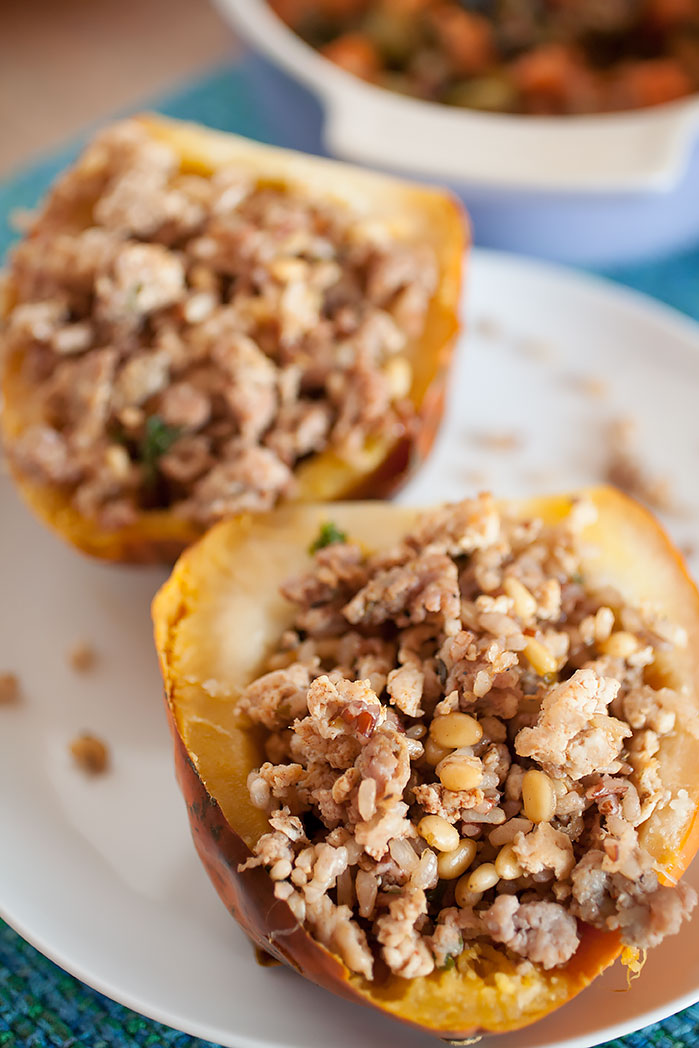 A simple, easy Thanksgiving side dish without much prep or time spent cooking! Acorn squash stuffed with savory sausage and turkey, rice, spice, and a bit of greens for a healthy crunch!