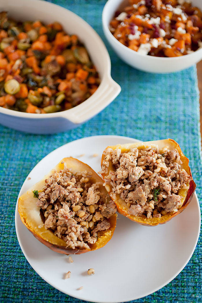 A simple, easy Thanksgiving side dish without much prep or time spent cooking! Acorn squash stuffed with savory sausage and turkey, rice, spice, and a bit of greens for a healthy crunch!