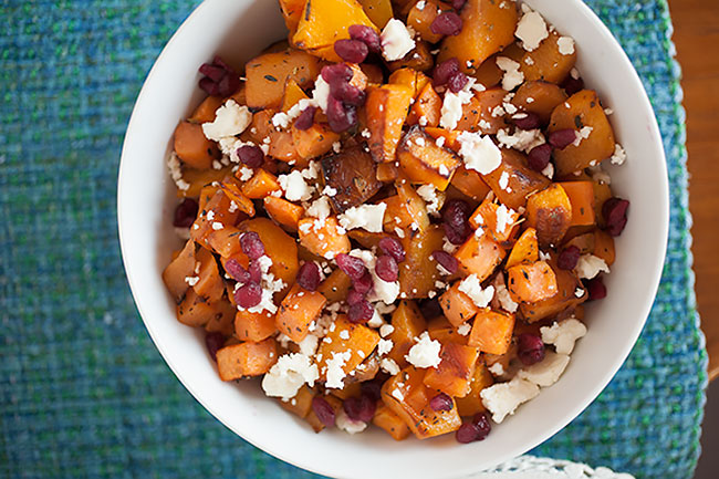 This easy Thanksgiving side dish has sweet from the butternut squash, sweet potatoes, and roasted onions, salty creaminess from the feta cheese, a delicious savory layer from the Greek herbs, and a sweet tang from the pomegranate seeds! And most of the work is done by the oven! 