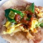 corn tortilla with scrambled eggs, potatoes, avocado, and salsa for breakfast tacos from Flurries of Flour